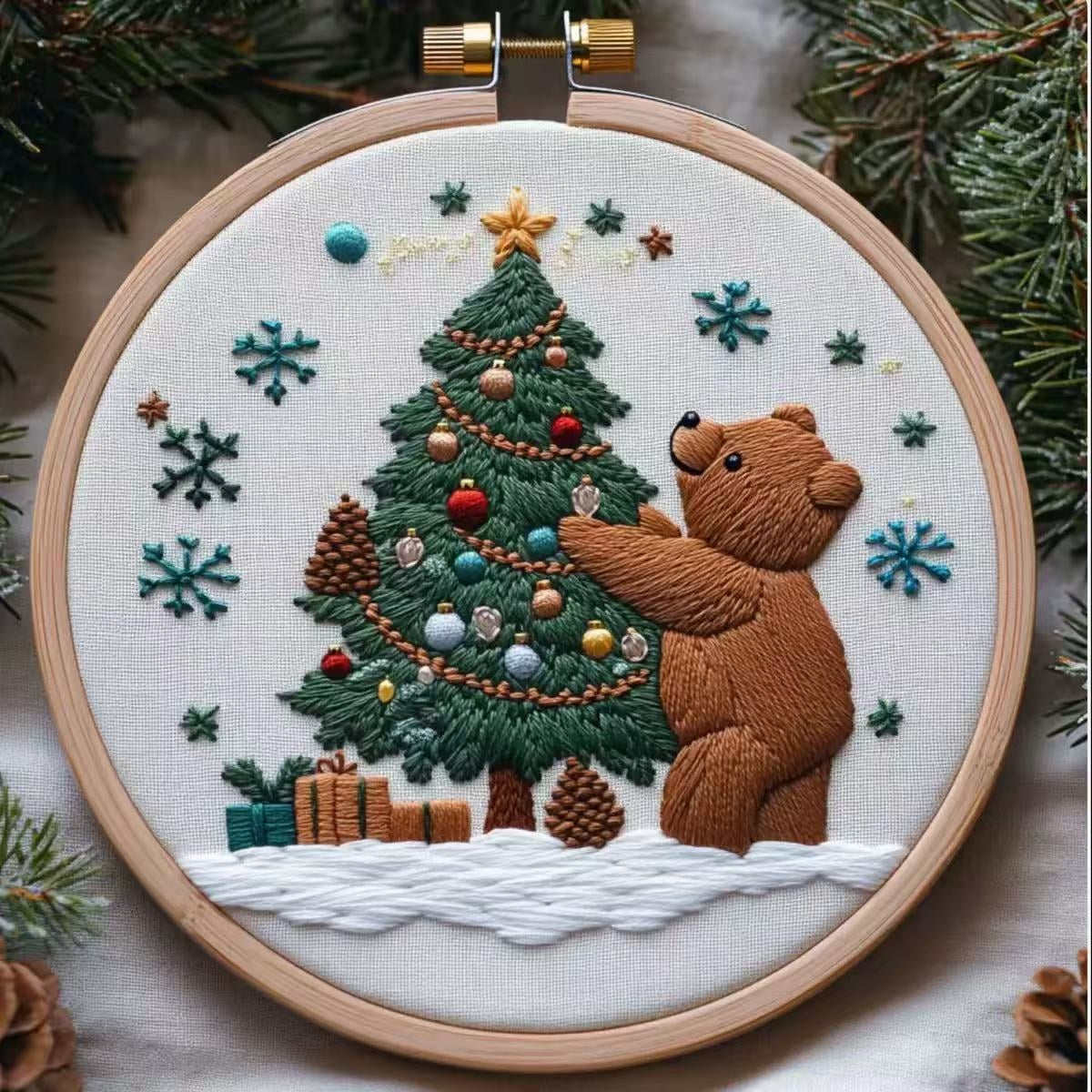 Embroidery hoop with a bear decorating a Christmas tree design.