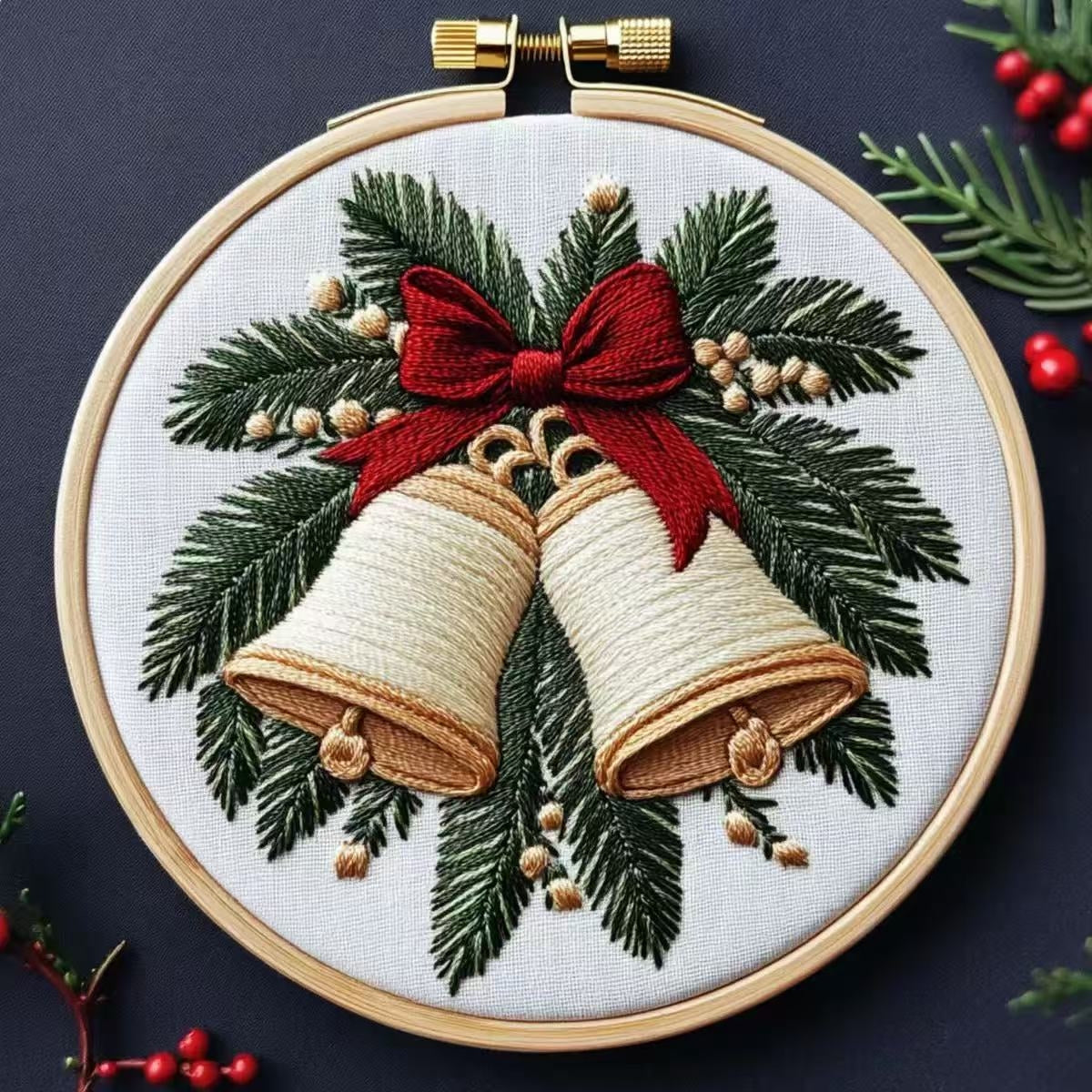 Embroidery hoop with Christmas design featuring bells and a bow.