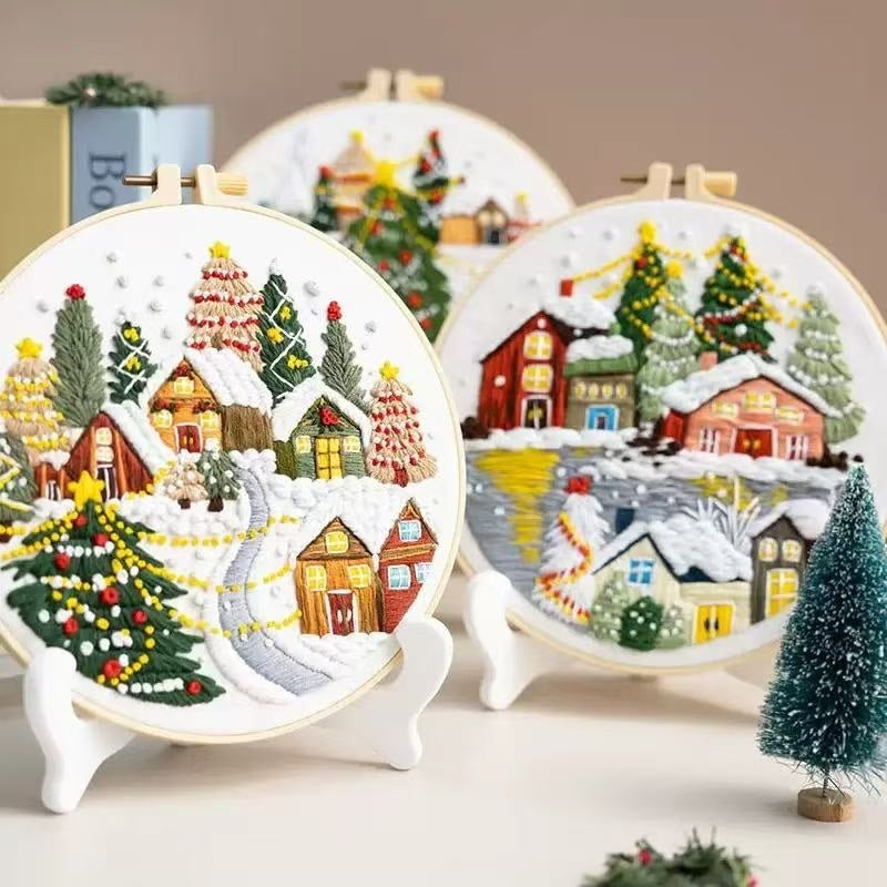Embroidery hoops with Christmas winter village scenes on a neutral background