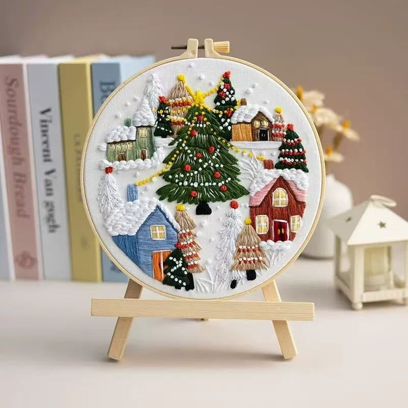 Decorative embroidery hoop with a Christmas scene on a stand