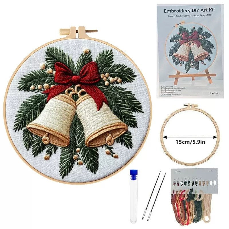 Embroidery DIY art kit with completed design of Christmas bells and greenery.