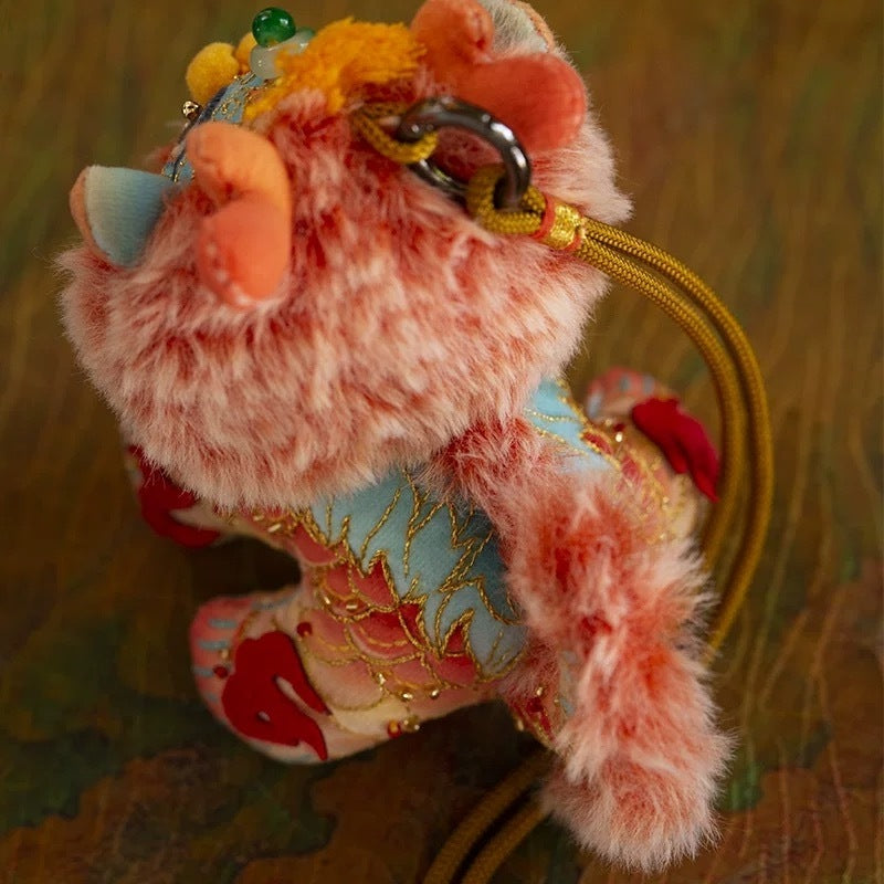 top view of a colorful, fluffy DIY embroidery kit in the shape of a mythical creature Kylin, with a ready-to-hang lanyard