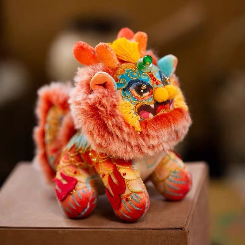 a colorful, fluffy DIY embroidery kit in the shape of a mythical creature Kylin on a box