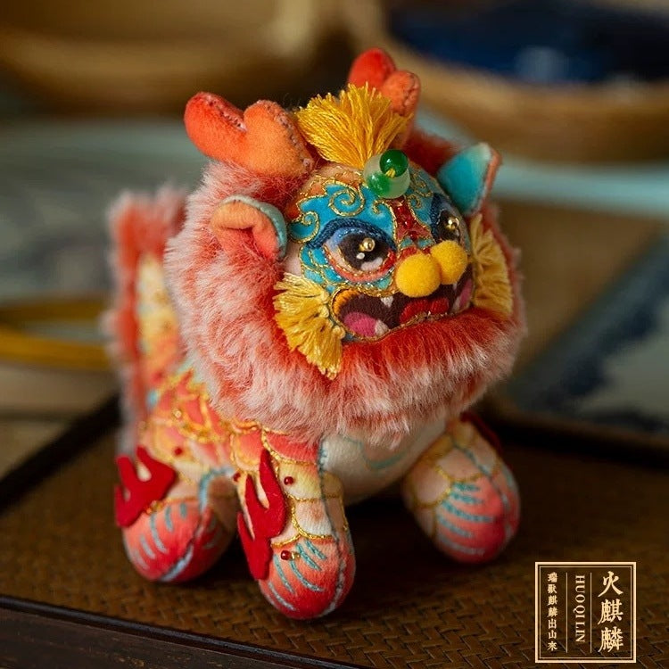 a colorful, fluffy embroidered fabric doll in the shape of a Chinese mythical creature Kylin on table