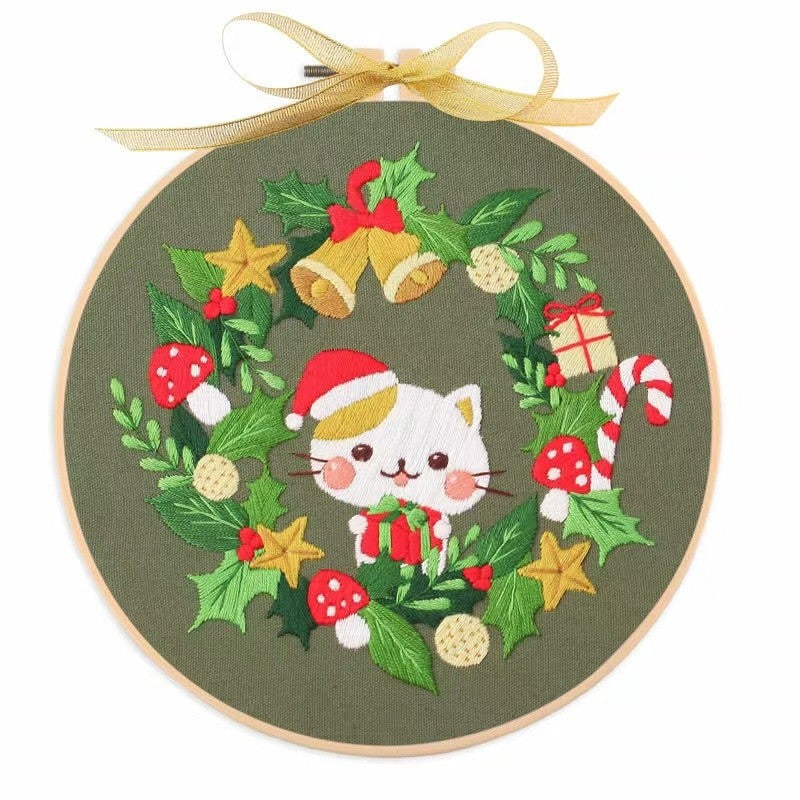 Christmas DIY Hand Embroidery Kit featuring holiday designs, including gingerbread houses, Christmas trees, wreaths, santa and festive kittens