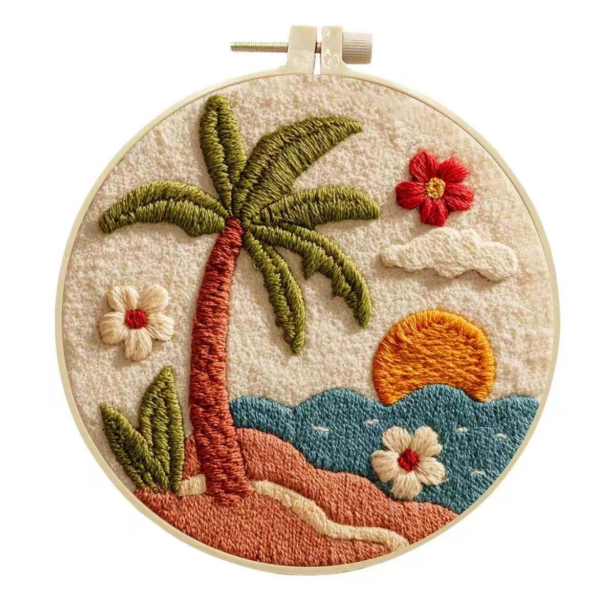 Embroidery hoop with a tropical scene including a palm tree, flowers, and sunset.