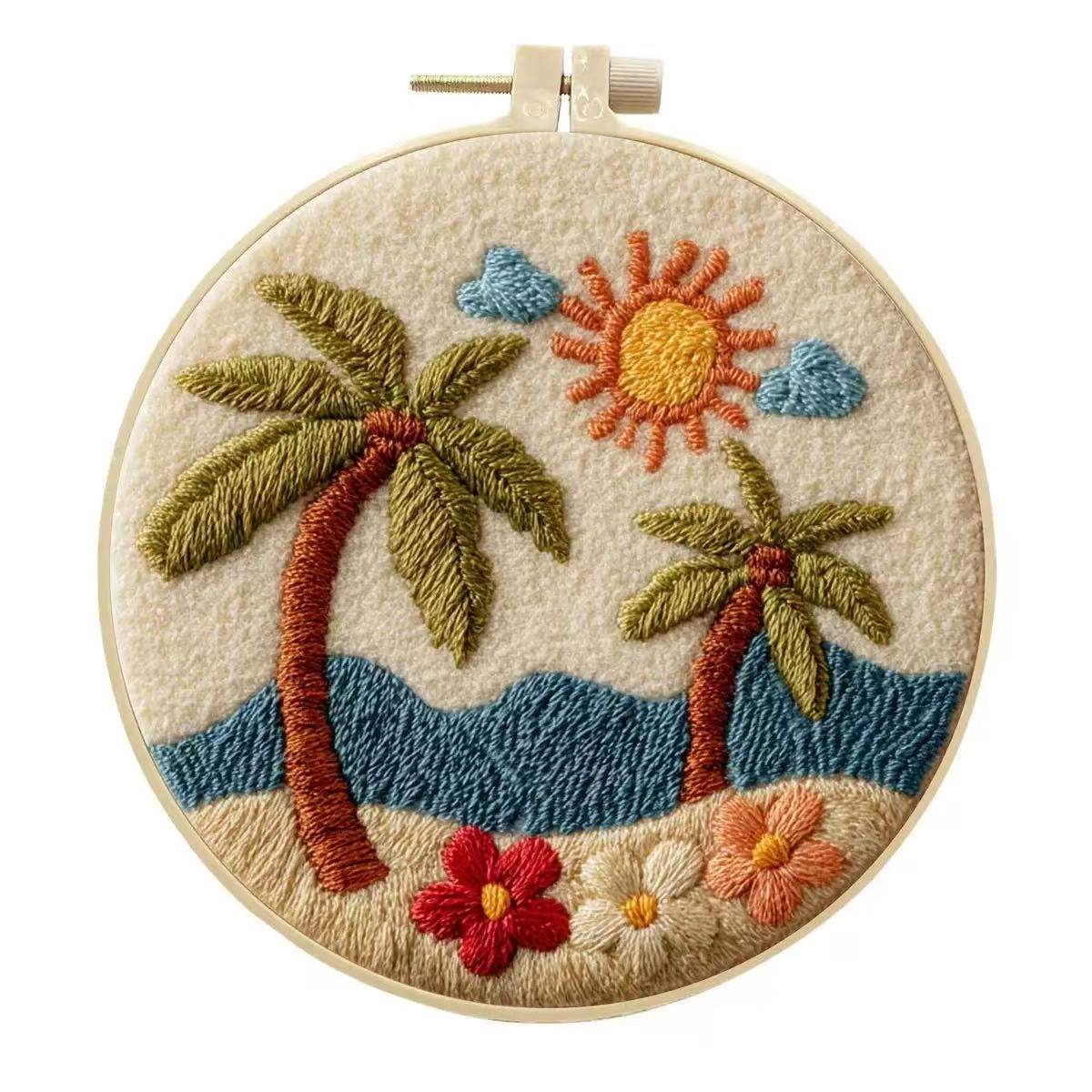 Embroidery hoop with a tropical scene including palm trees, sun, and flowers on a beige background.