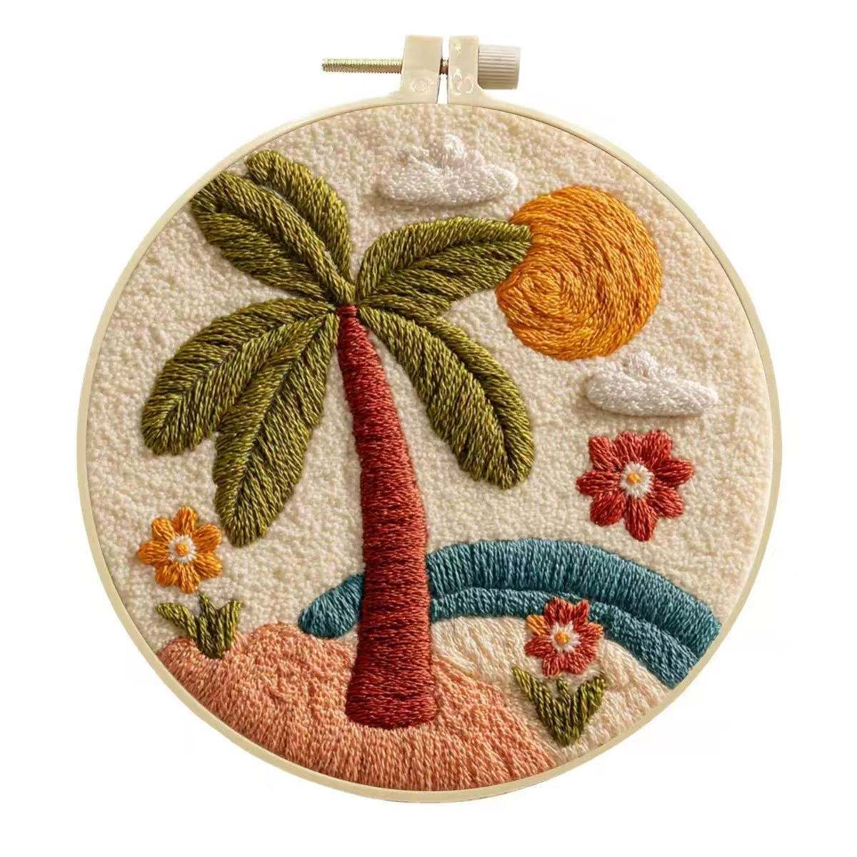 Embroidery hoop with a tropical scene including a palm tree, sun, and flowers.