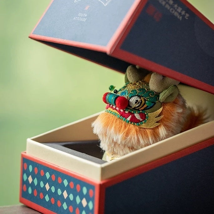 Colorful embroidered Chinese beast Kylin toy doll inside an open gift box