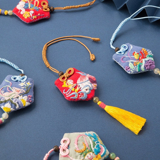 image displaying the finished 12 Chinese Zodiac Amulet Fortune Charm Hand Embroidery Kits on table