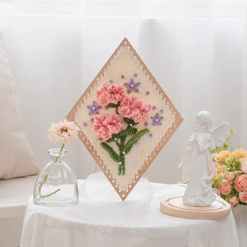 image displaying a finished Carnation Flower Weaving Loom Kit in a table setting