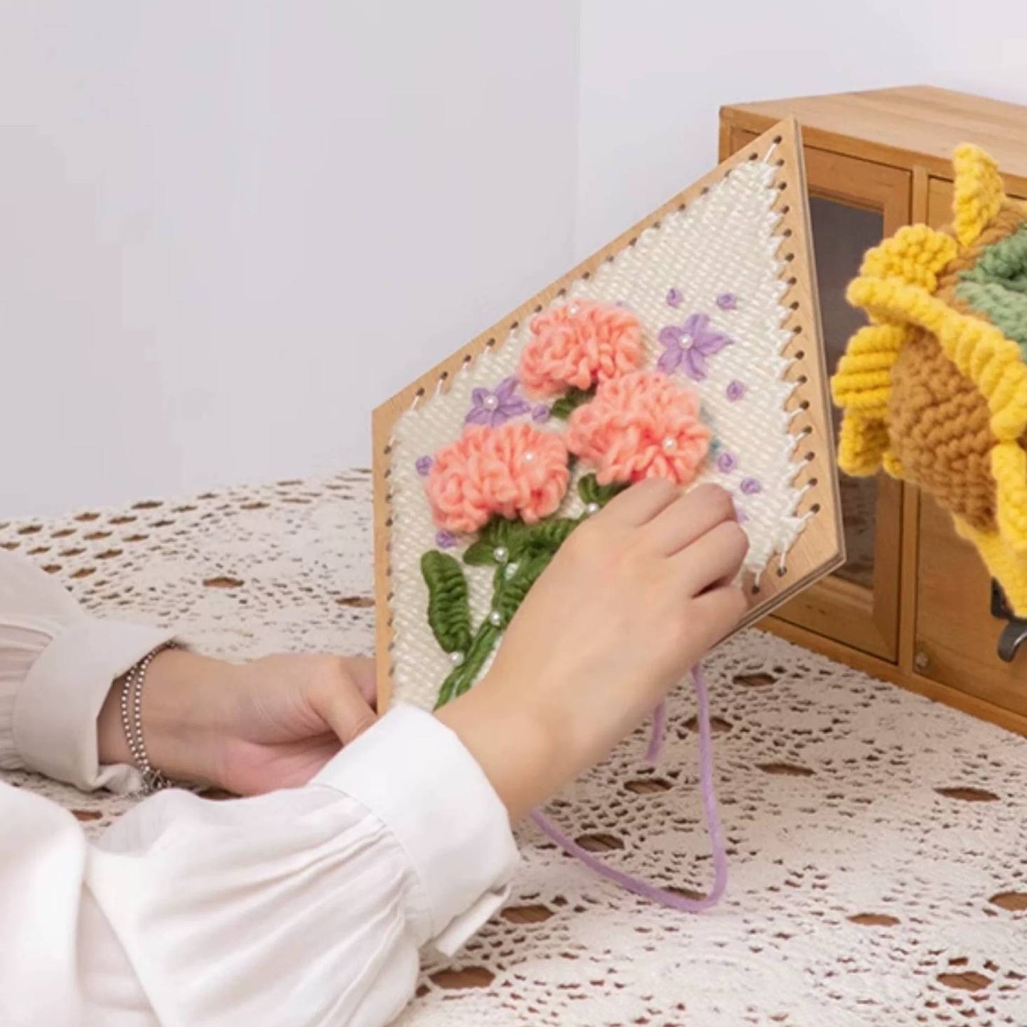 image displaying a weaving process of Carnation Flower Weaving Loom Kit