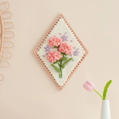 image displaying a finished Carnation Flower Weaving Loom Kit hanging on wall as a decoration