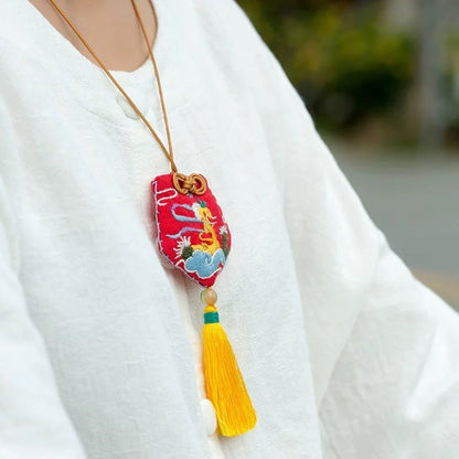 image displaying a woman wearing the embroidered Chinese Monkey Zodiac Amulet Fortune Charm as necklace