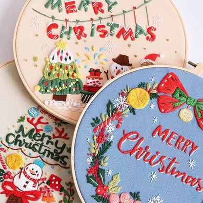 close-up of the finished Christmas DIY hand embroidery kit bundle, including Christmas wreath, Santa's Workshop, Christmas tree, Snowman and gingerbread designs