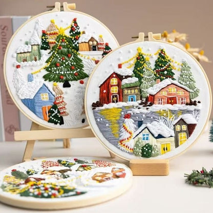 Three embroidered Christmas scenes in hoops on a neutral background