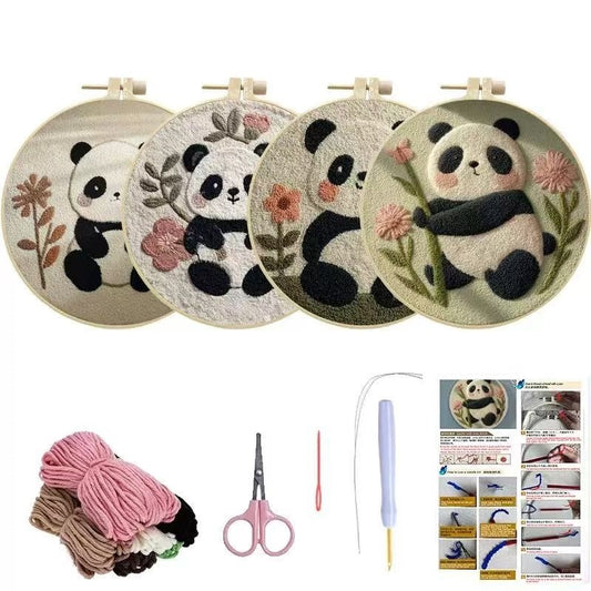 Set of embroidered panda designs on fabric hoops with yarn, scissors, and a needle