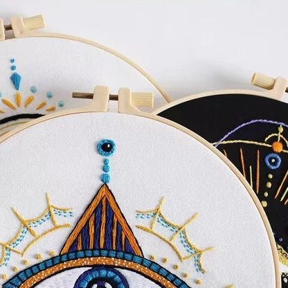Embroidery hoops with colorful geometric embroidery on a white background