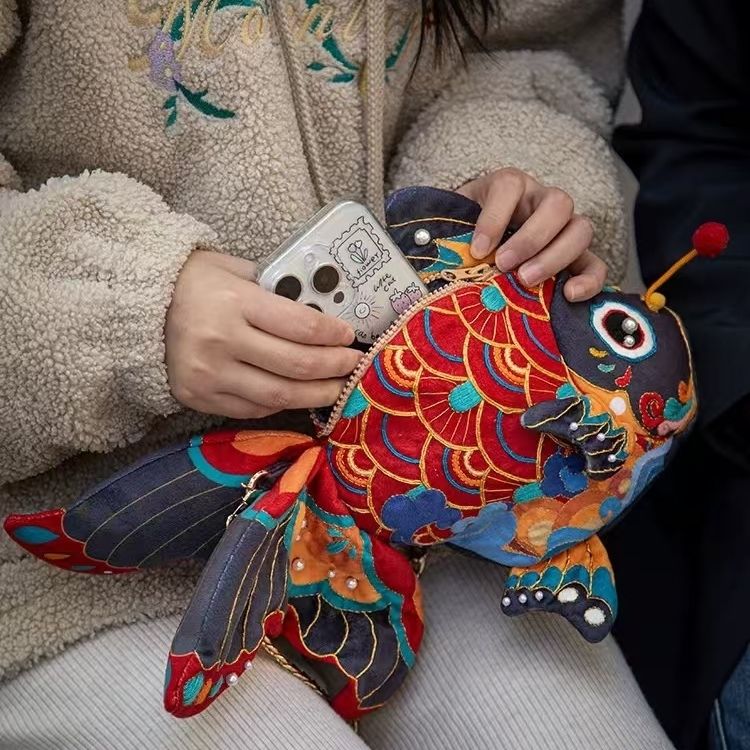 image of a phone putting into the hand-embroidered Koi Fish Bag