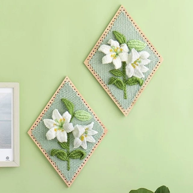 image displaying two finished Lily Flower Weaving Loom Kit hanging on the wall as home decoration