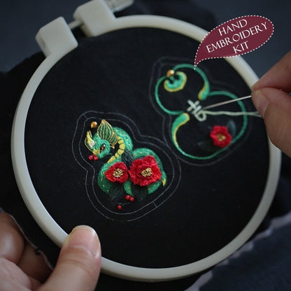 Completed Snake Fortune Charm embroidery in hoop, displaying vibrant colors and traditional Chinese elements