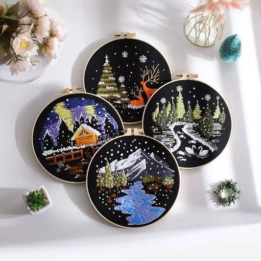 Set of embroidery hoop artworks with winter scenes on a white background