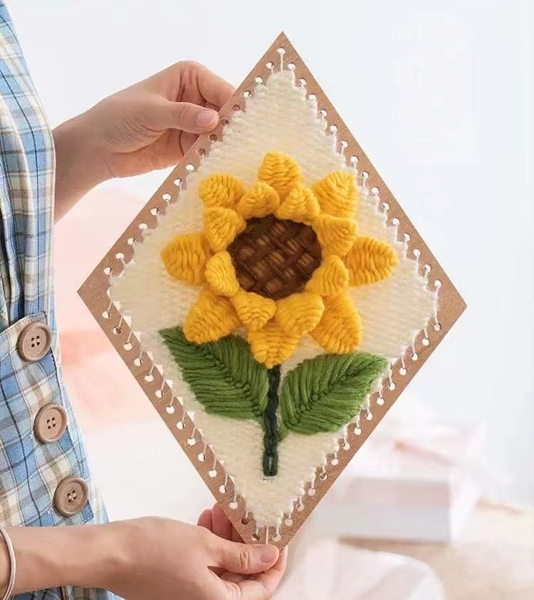 the finished Sunflower Weaving Loom Kit is holding in hands to showcase its texture and design