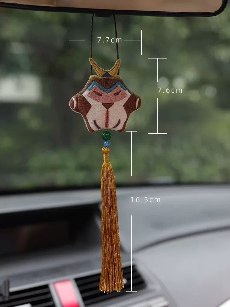 DIY embroidery kit featuring Wu Kong (Monkey King) amulet design. Includes fabric with pre-printed pattern, embroidery hoop, colorful threads, needle, and instructions. Completed amulet shows stylized Monkey King figure with Chinese characters, symbolizing good fortune and protection.